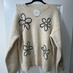 Storia Beige Sweater with Black Floral Pattern